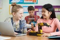 Two Female Pupils In Science Lesson Studying Robotics