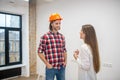 Female purchaser talking to the construction worker Royalty Free Stock Photo