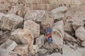 Tourist Posing on the Fallen Stones of the Second Temple in Jerusalem Royalty Free Stock Photo
