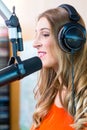 Female radio presenter in radio station on air Royalty Free Stock Photo