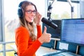 Female radio presenter in radio station on air