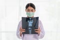 Female Radiology Doctor Examining At X Ray Film Of Patient At Hospital Room, Lung Radiography Concept