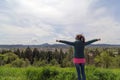 Female raised arms at top of Skinner Butte Park