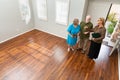 Female Real Estate Agent Handing New House Keys to Senior Adult Royalty Free Stock Photo