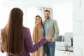 Female real estate agent showing new house to couple Royalty Free Stock Photo