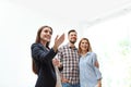 Female real estate agent showing new house to couple Royalty Free Stock Photo