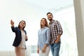 Female real estate agent showing new house to couple Royalty Free Stock Photo