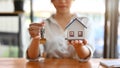 A female real estate broker or realtor holding a house model and house keys Royalty Free Stock Photo