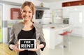 Female real estate seller holding tablet with for rent text