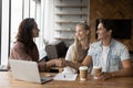 Female realtor shaking hands with clients in office. Royalty Free Stock Photo