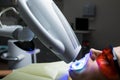 Female receiving teeth whitening procedure. Portrait of a female patient at dentist in the clinic. Teeth whitening procedure with Royalty Free Stock Photo