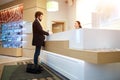 Female receptionist giving information to guest upon arrival at hotel. Royalty Free Stock Photo