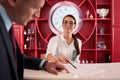 Female receptionist pointing on place of sign on document