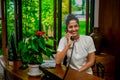 Female receptionist staff communicating using phone during duty hours at the tropical resort Royalty Free Stock Photo