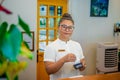 Female receptionist staff working with card machine during duty hours at the tropical resort