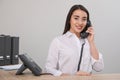 Female receptionist talking on phone at workplace Royalty Free Stock Photo