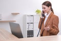 Female receptionist talking on phone at workplace Royalty Free Stock Photo