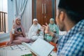 female recitation participants raise their hands when asking questions