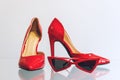 Female red fashion accessories. Red women heel shoes and trendy red cat eye sunglasses on the shelf in the store shop. Set of Royalty Free Stock Photo