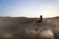 Female relaxing on the sand dune, admiring the oasis town of Huacachina, Ica, Peru.The sunset desert view Royalty Free Stock Photo