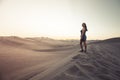 Female relaxing on the sand dune, admiring the oasis town of Huacachina, Ica, Peru.The sunset desert view Royalty Free Stock Photo