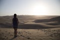 Female relaxing on the sand dune, admiring the oasis town of Huacachina, Ica, Peru.The sunset desert view Royalty Free Stock Photo