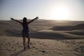 Female relaxing on the sand dune, admiring the oasis town of Huacachina, Ica, Peru.The sunset desert view Royalty Free Stock Photo