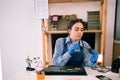 Female repairman working in technical support fixing computer laptop. Disassembling a notebook and cleaning its cooling