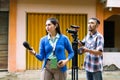 a female reporter hunting for news with a cameraman