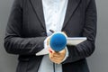 Female reporter at press conference or media event, writing notes, holding microphone Royalty Free Stock Photo