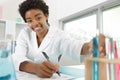 female reseacher writes notes in lab Royalty Free Stock Photo