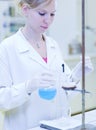 Female researcher carrying out titration Royalty Free Stock Photo