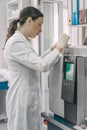 Female researcher doing research in a chemistry lab. Gas chromatograph Royalty Free Stock Photo