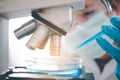 Female researchers are experimenting with pipette dropping a sample into a test tube in an experiment research in laboratory