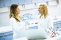 Female researchers in white lab coat using laptop while working in the laboratory