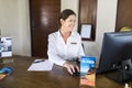 Female resort receptionist working on a computer Royalty Free Stock Photo