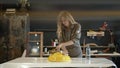 A female restorer painting a yellow detail in workshop. Lense flare