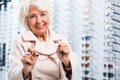 Female retiree in optician store