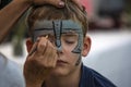 Female retoucher puts on make-up for a firefighter holiday in Halle Saale, Germany, 2019