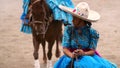 Female rider in blue dress