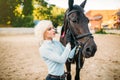 Female rider hugs her horse, horseback riding Royalty Free Stock Photo