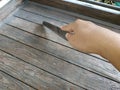 Female right hand with Steel kitchen knife on brown wooden chair