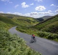 Female road cyclist descending Boundary Hill, Trough of Bowland, UK.