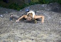Female rock climber clinging to a cliff Royalty Free Stock Photo
