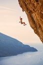 Female rock climber falling of a cliff while lead climbing Royalty Free Stock Photo