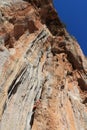 Female rock climber on handholds on challenging route on cliff Royalty Free Stock Photo