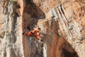 Female rock climber on handholds on challenging route on cliff Royalty Free Stock Photo