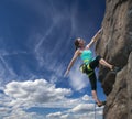 Female rock climber hanging over the abyss Royalty Free Stock Photo