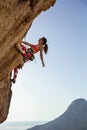 Female rock climber looking up at challenging route