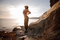 Female rock climber watching sunset over sea Royalty Free Stock Photo